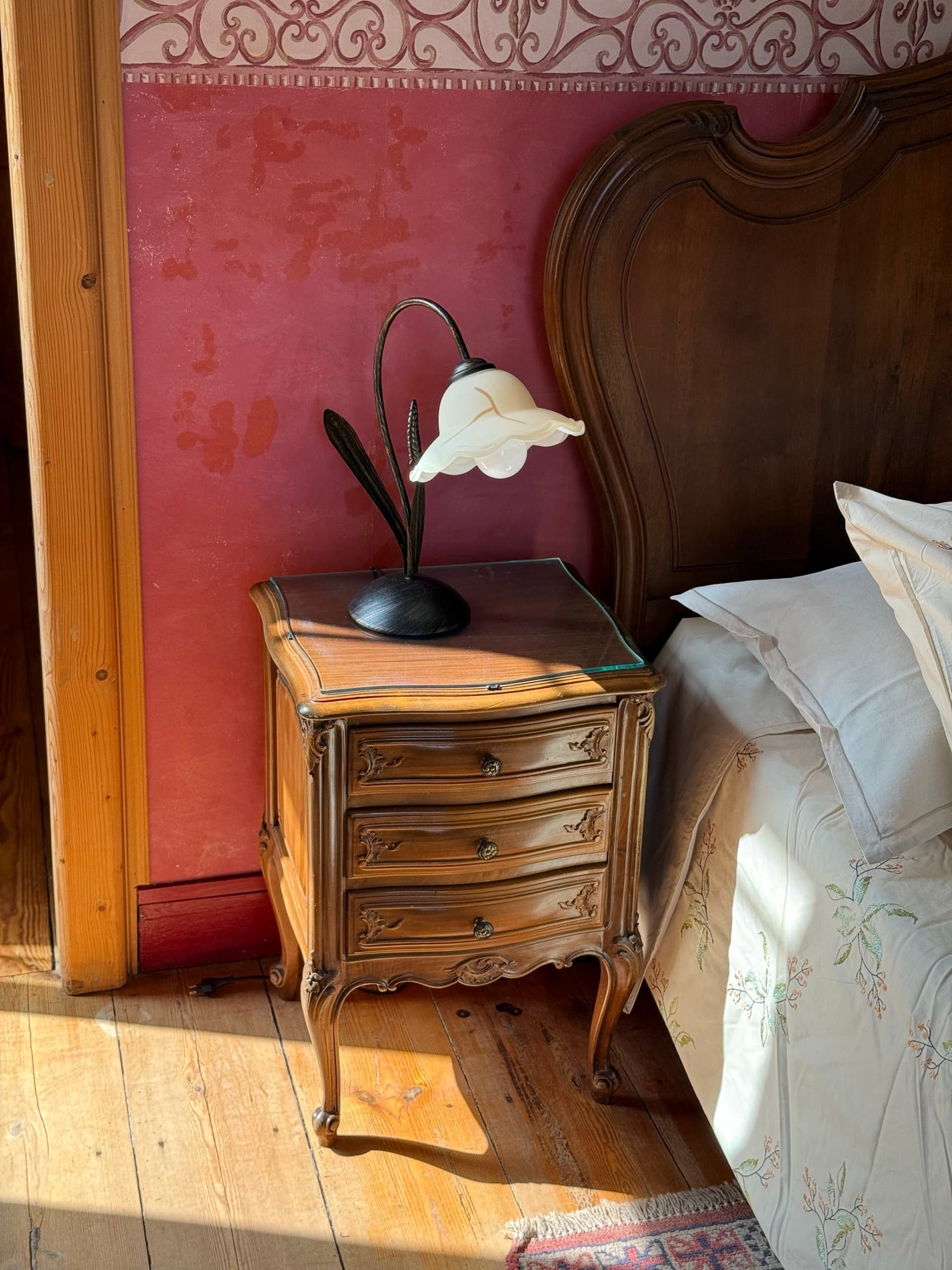 Antique bedside table in the Mascaret room